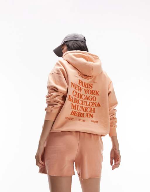 Topshop graphic vintage wash city oversized hoodie in peach ASOS