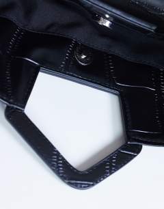 Model wearing Gregry folded clutch bag in black croc