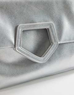 Model wearing Gregry oversized folded clutch bag in silver
