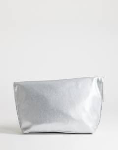 Model wearing Gregry oversized folded clutch bag in silver