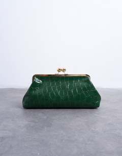 Model wearing Gretchen clutch grab back in green