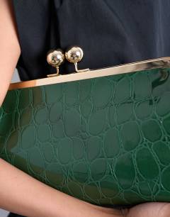 Model wearing Gretchen clutch grab back in green