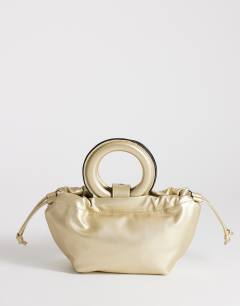 Model wearing Grette grab bag in gold