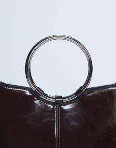 Model wearing Griffith metal ring handle grab bag in chocolate