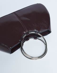Model wearing Griffith metal ring handle grab bag in chocolate