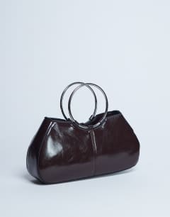 Model wearing Griffith metal ring handle grab bag in chocolate