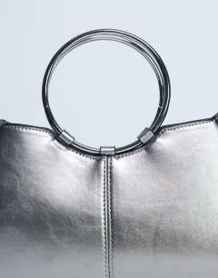 Model wearing Griffith metal ring handle grab bag in silver