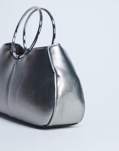 Model wearing Griffith metal ring handle grab bag in silver