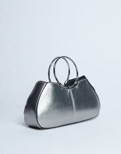 Model wearing Griffith metal ring handle grab bag in silver