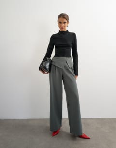 Model wearing Grown on neck zip long sleeve top in black