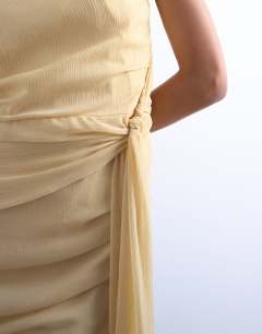 Model wearing Grown on shoulder chiffon mini dress with sash in textured buttermilk