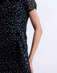 Model wearing Grown on shoulder sash dress in mono spot