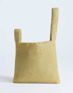 Model wearing Gwyn embellished grab bag in gold