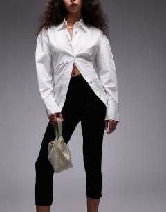 Model wearing Gwyn embellished knot grab bag in gold