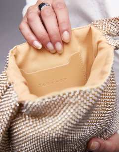 Model wearing Gwyn embellished knot grab bag in gold