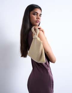 Model wearing Gwyn embellished knot grab bag in gold