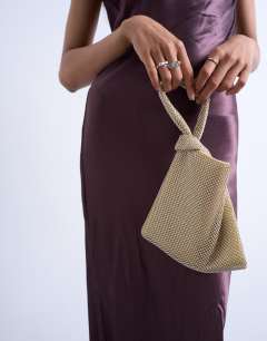 Model wearing Gwyn embellished knot grab bag in gold