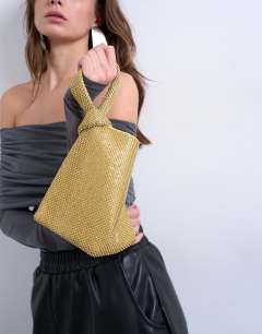 Model wearing Gwyn small embellished knot grab bag in gold
