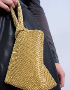Model wearing Gwyn small embellished knot grab bag in gold