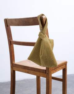 Model wearing Gywn embellished knot grab bag in gold