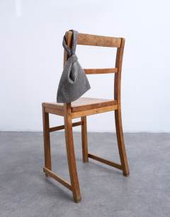 Model wearing Gywn embellished knot grab bag in pewter