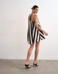 Model wearing Halter deep hem mini trapeze dress in mono stripe