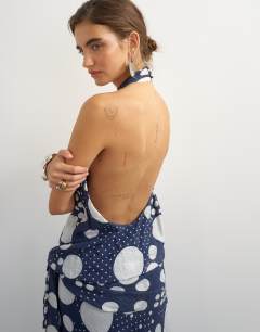 Model wearing Halter neck dropped waist tie detail maxi dress in black mixed spot