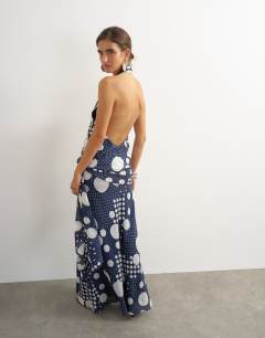 Model wearing Halter neck dropped waist tie detail maxi dress in black mixed spot