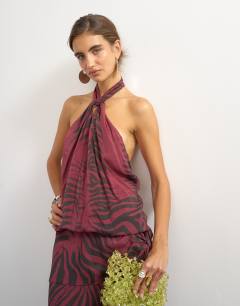 Model wearing Halter neck dropped waist tie detail maxi dress in burgundy zebra print