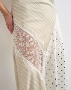 Model wearing Halter neck lace insert maxi dress om contrast stripe and polka dot print
