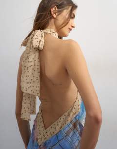 Model wearing Halter neck tucked side maxi dress in check ad polka dot