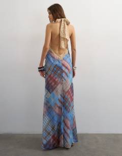 Model wearing Halter neck tucked side maxi dress in check ad polka dot