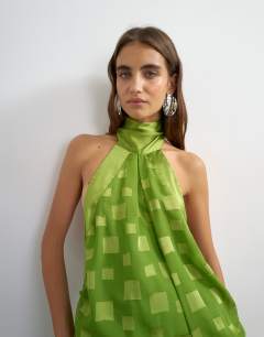 Model wearing Halter neck tucked side maxi dress with burnout square print detail in green