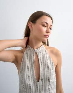 Model wearing Halter top with keyhole detail in woven black stripe