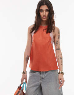 Model wearing Halterneck top with contrast lace in deep orange