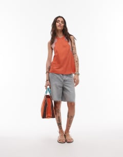 Model wearing Halterneck top with contrast lace in deep orange