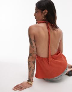 Model wearing Halterneck top with contrast lace in deep orange