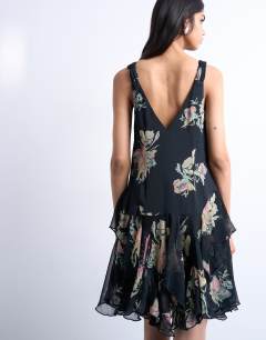Model wearing Hanky hem mini dress with pinched straps in black based floral