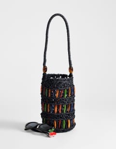 Model wearing Harley raffia grab bag with beads in black & multi