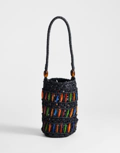 Model wearing Harley raffia grab bag with beads in black & multi