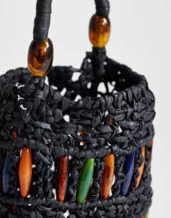 Model wearing Harley raffia grab bag with beads in black & multi