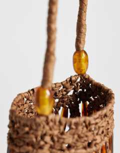 Model wearing Harley raffia grab bag with beads in brown & tort