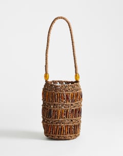 Model wearing Harley raffia grab bag with beads in brown & tort