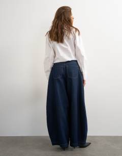 Model wearing Harper baggy barrel jean in rinse wash