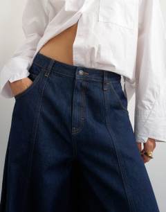 Model wearing Harper baggy barrel jean in rinse wash