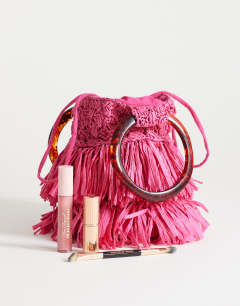 Model wearing Harper tassel straw grab bag in pink