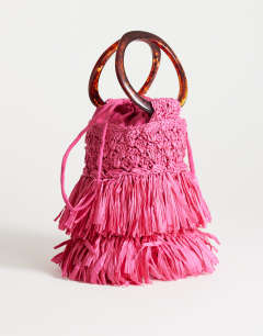 Model wearing Harper tassel straw grab bag in pink