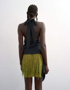 Model wearing Heavy beaded mini skirt in green