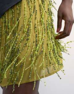 Model wearing Heavy beaded mini skirt in green