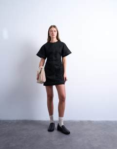 Model wearing Heavy twill contrast stitch short sleeve mini dress in black